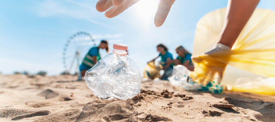 People collecting plastic waste on the beach